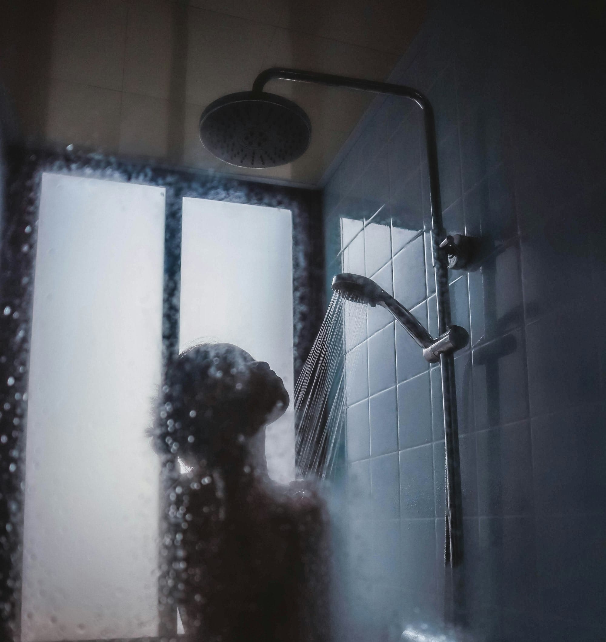 woman under showerhead
